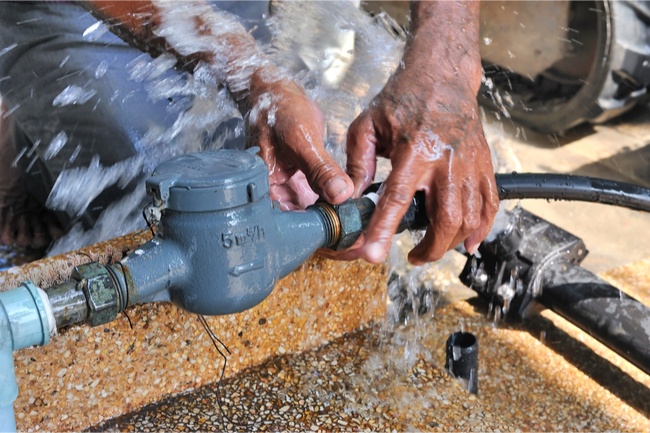 Plumber fixing leaky pipes